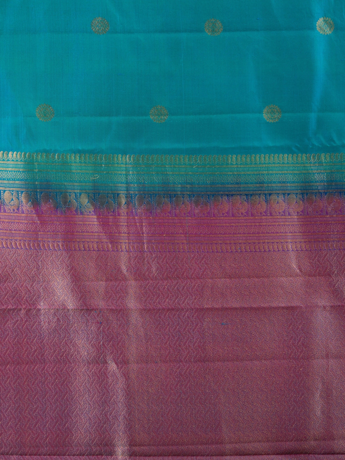 Teal blue pure Kanchipuram silk saree with contrast magenta border and gold zari buttas