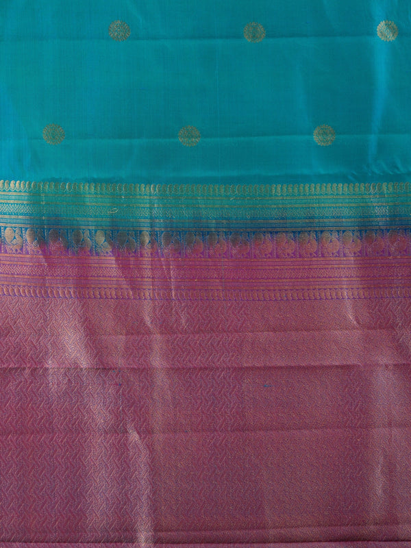 Teal blue pure Kanchipuram silk saree with contrast magenta border and gold zari buttas