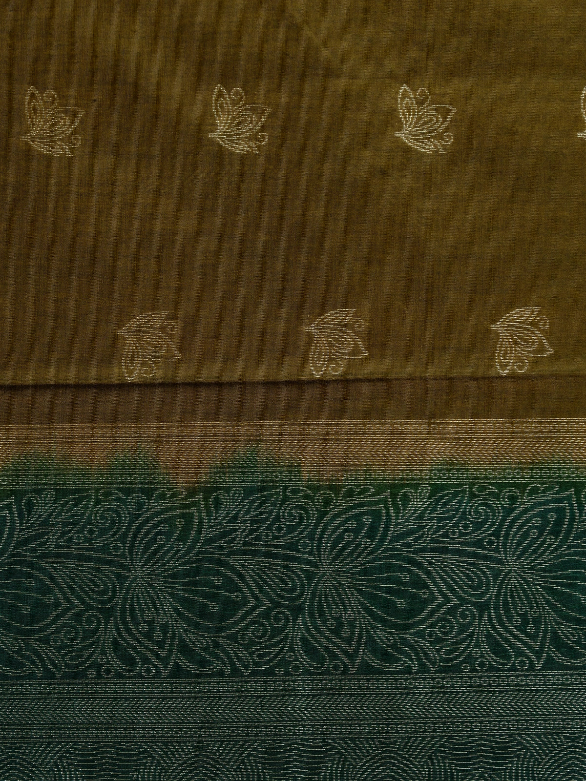 Mehendi green silk cotton saree with contrast bottle green zari border and silver lotus buttas