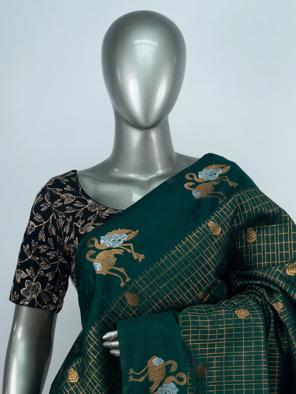 Bottle green semi raw silk saree with gold zari checks, yali motifs and contrast black embroidered blouse