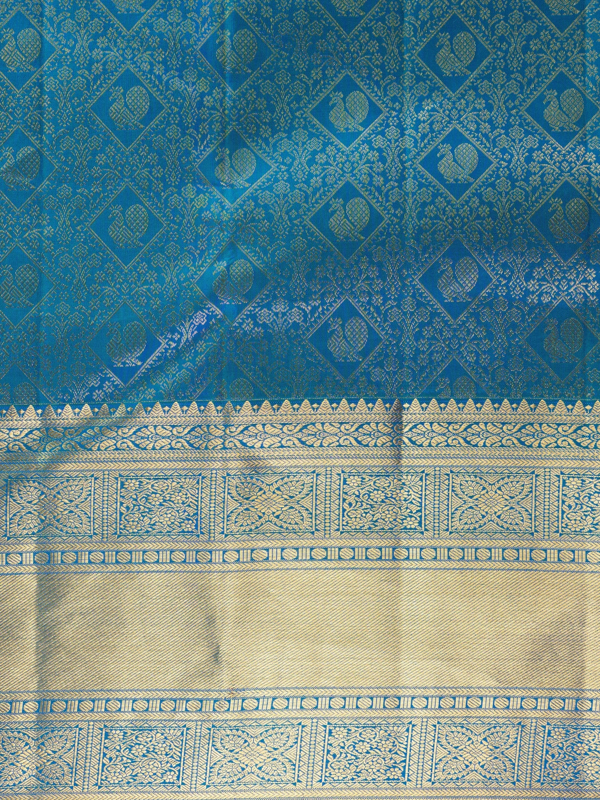 Peacock blue pure Kanchipuram silk saree with all-over gold zari brocade, peacock motifs and broad contrast gold zari border