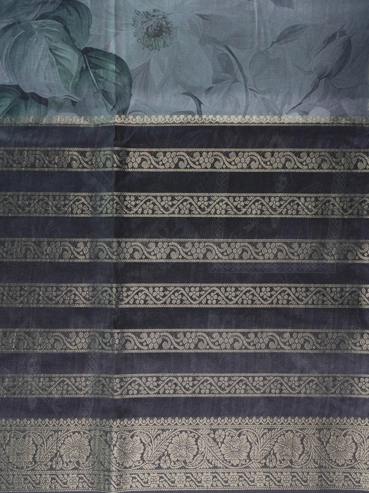 Charcoal grey semi tussar saree with gold zari stripes, floral prints, and a woven gold border