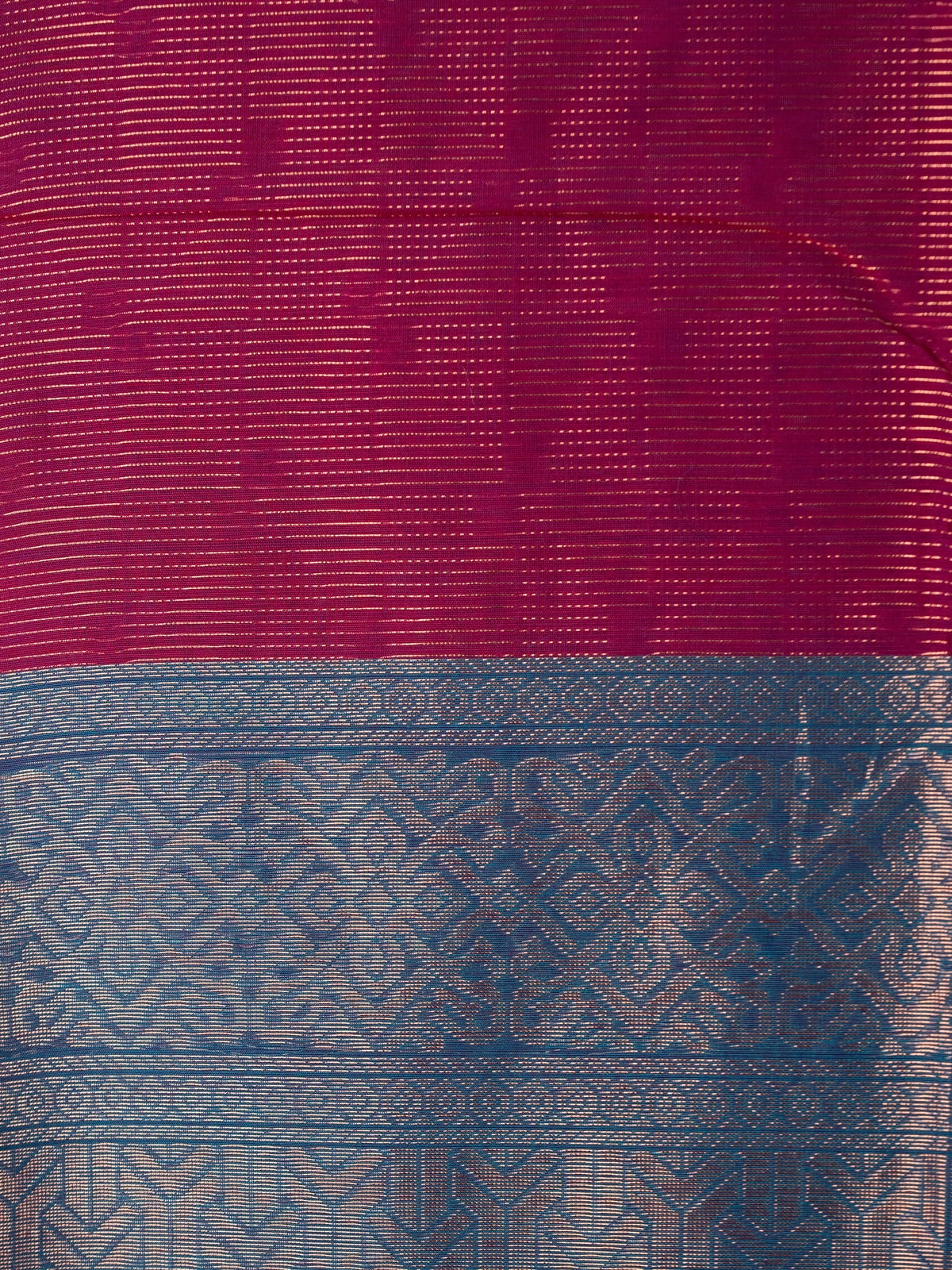 Magenta silk cotton saree with gold zari stripes and contrast blue zari border and pallu