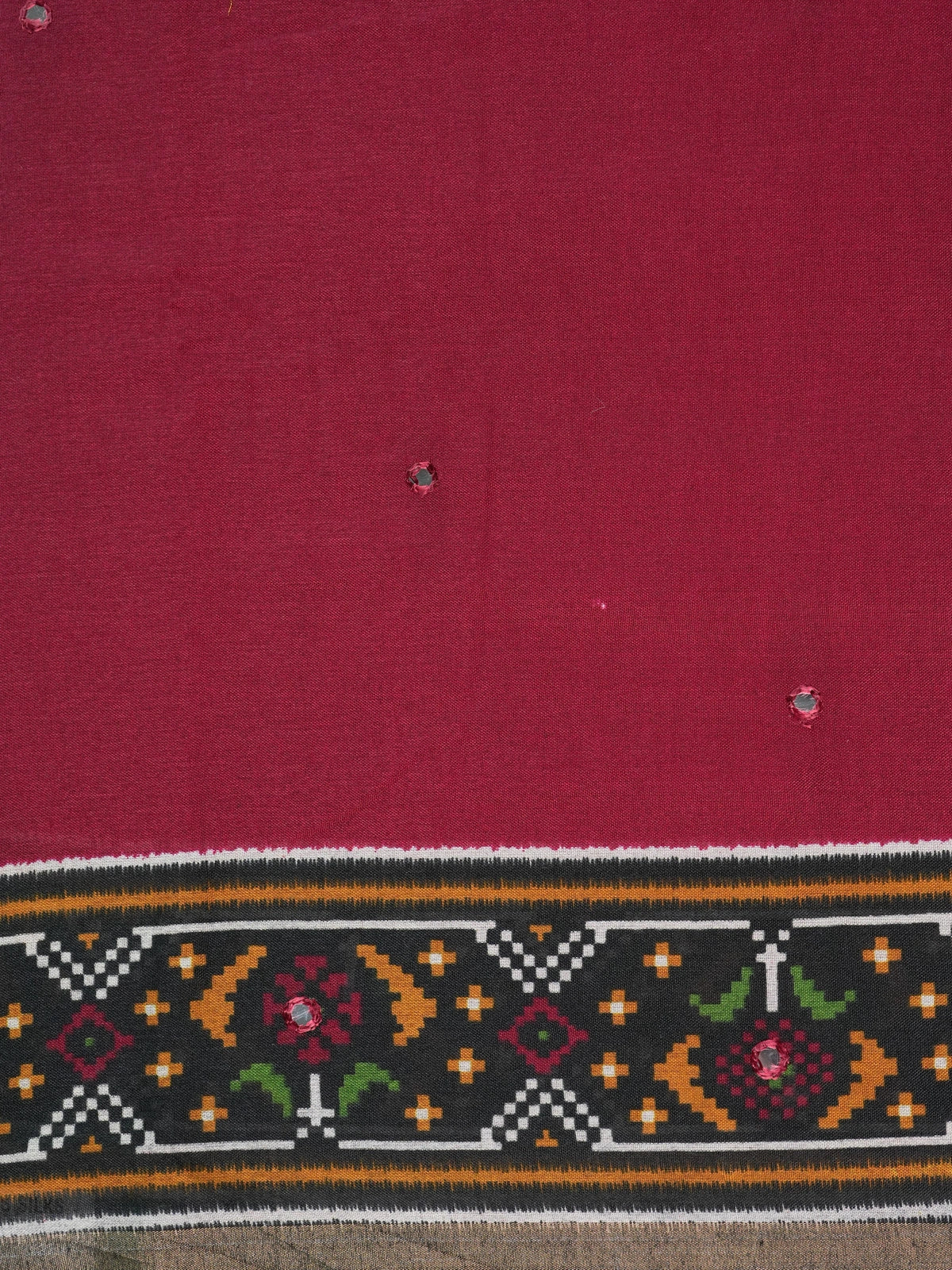Maroon Dola silk saree with black patola-style border, multicolour pallu and mirror work