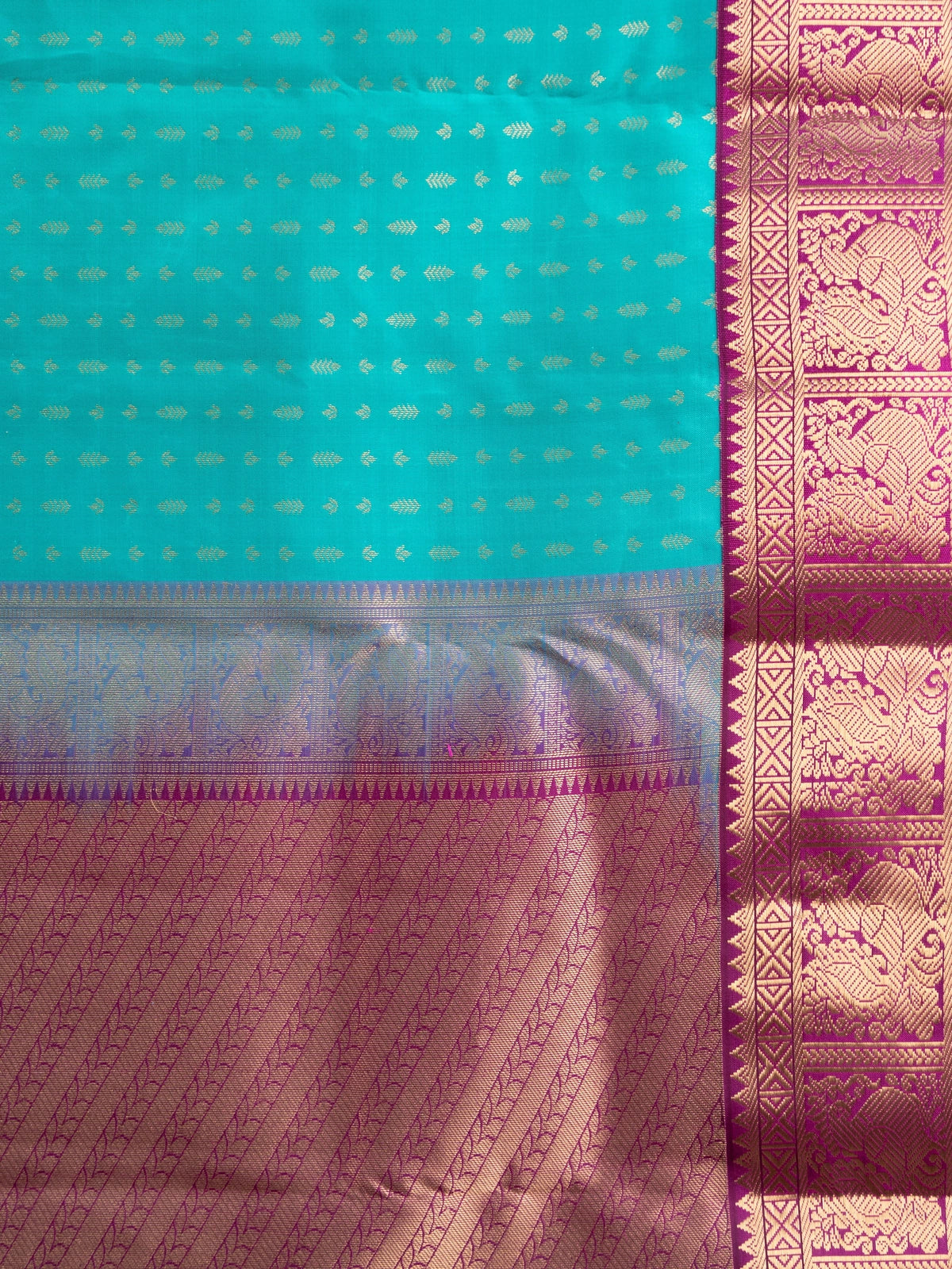 Teal pure Kanchipuram silk saree with gold zari butis and contrast magenta zari border and pallu
