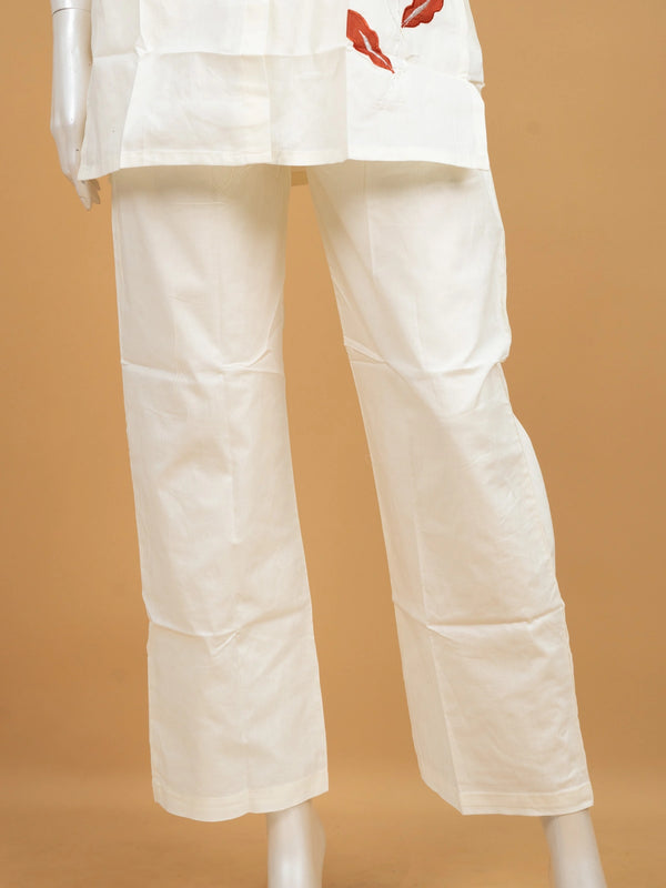 Off-white cotton co-ord set kurti with rust-red floral appliqué and straight pants