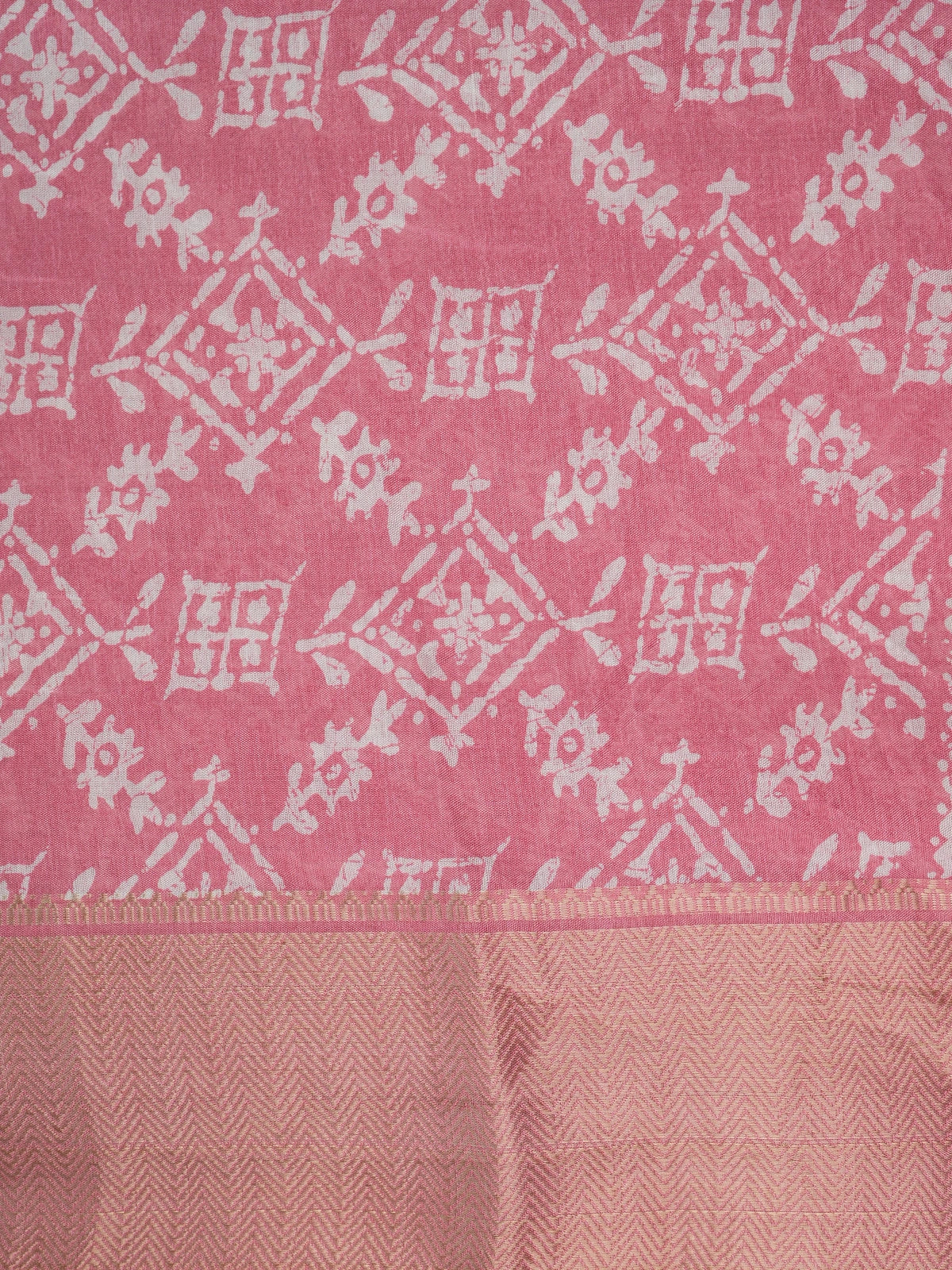 Pink and white batik-print designer cotton saree with gold zari border