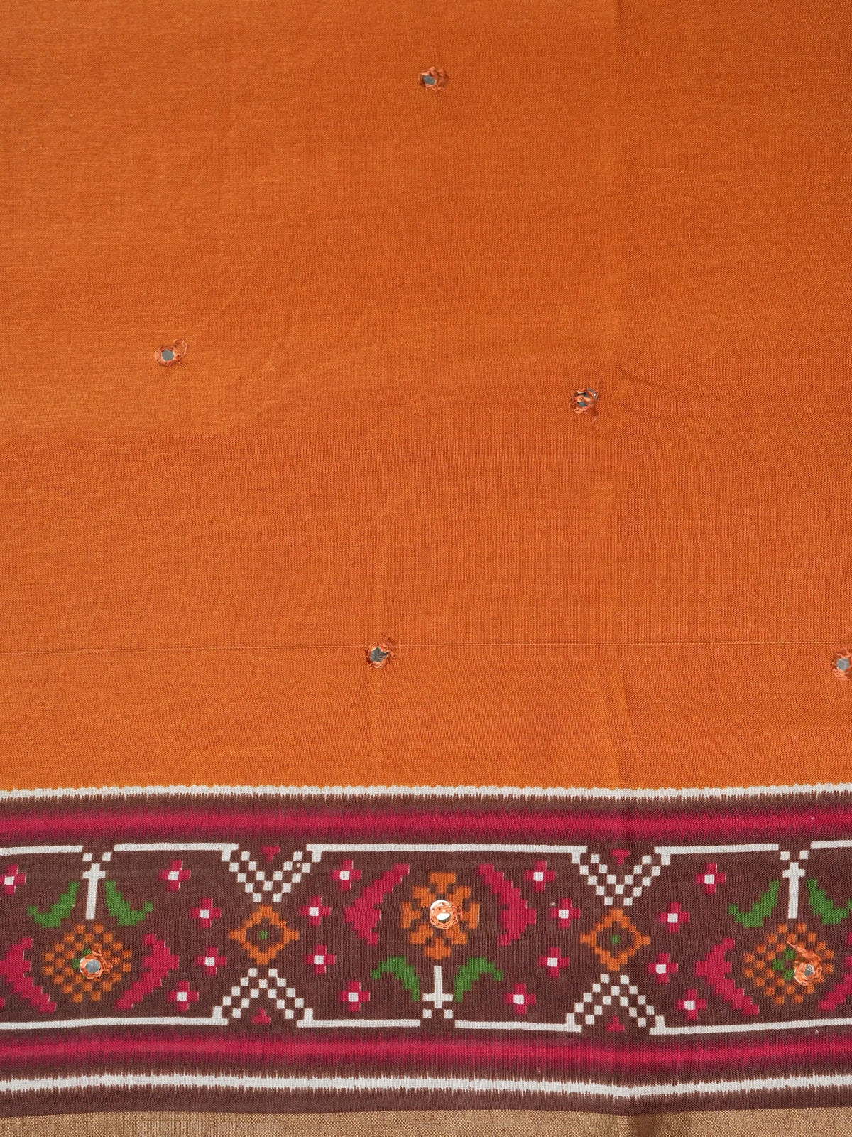 Rust orange linen cotton saree with patola-print brown border, mirror-work buttis and contrast blouse