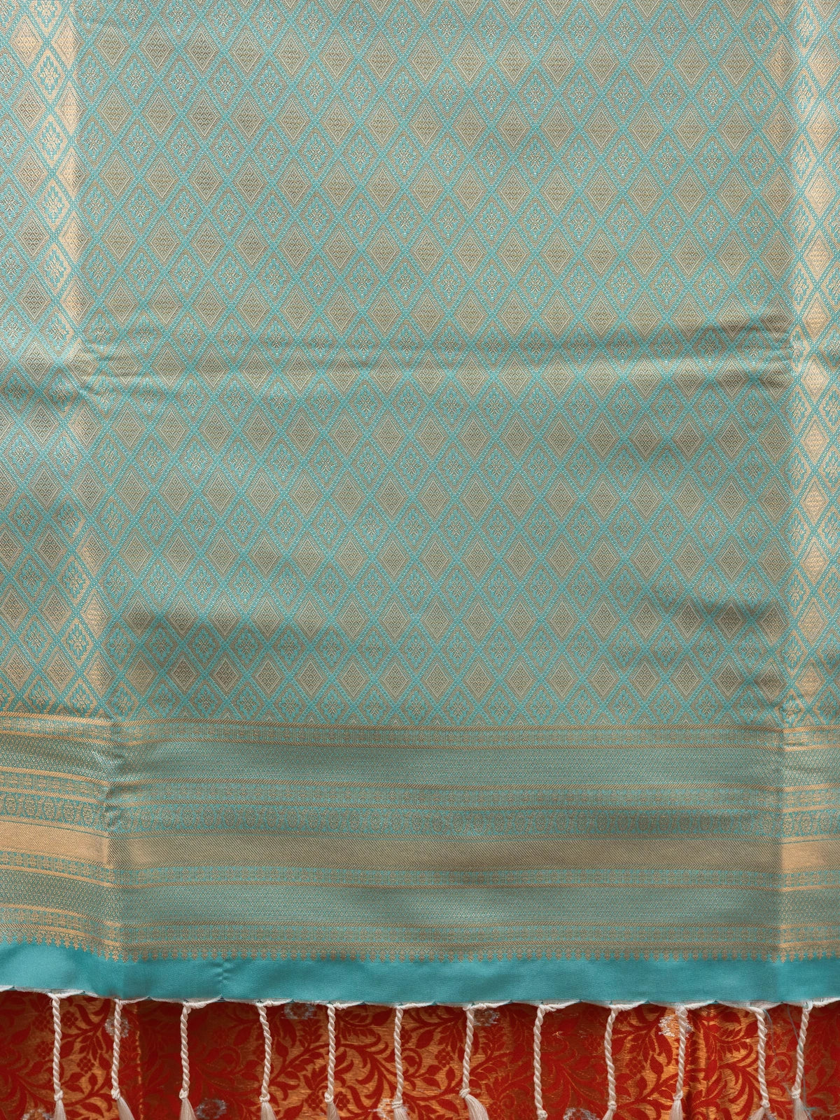 Orange Kanchipuram fancy silk saree with turquoise contrast border, gold zari floral body and diamond-patterned pallu