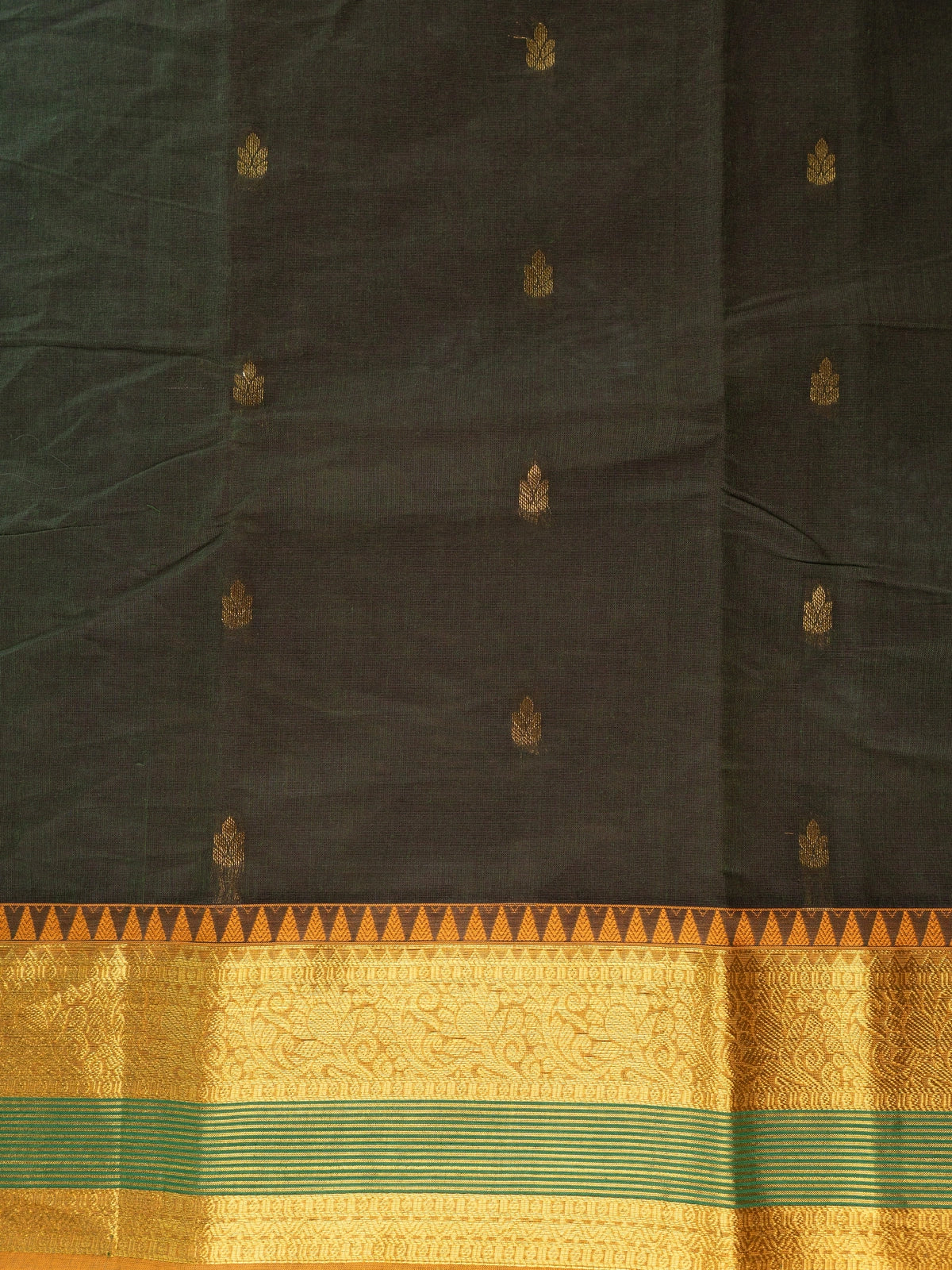 Dark green Chettinad cotton saree with mustard gold zari border and woven floral pallu