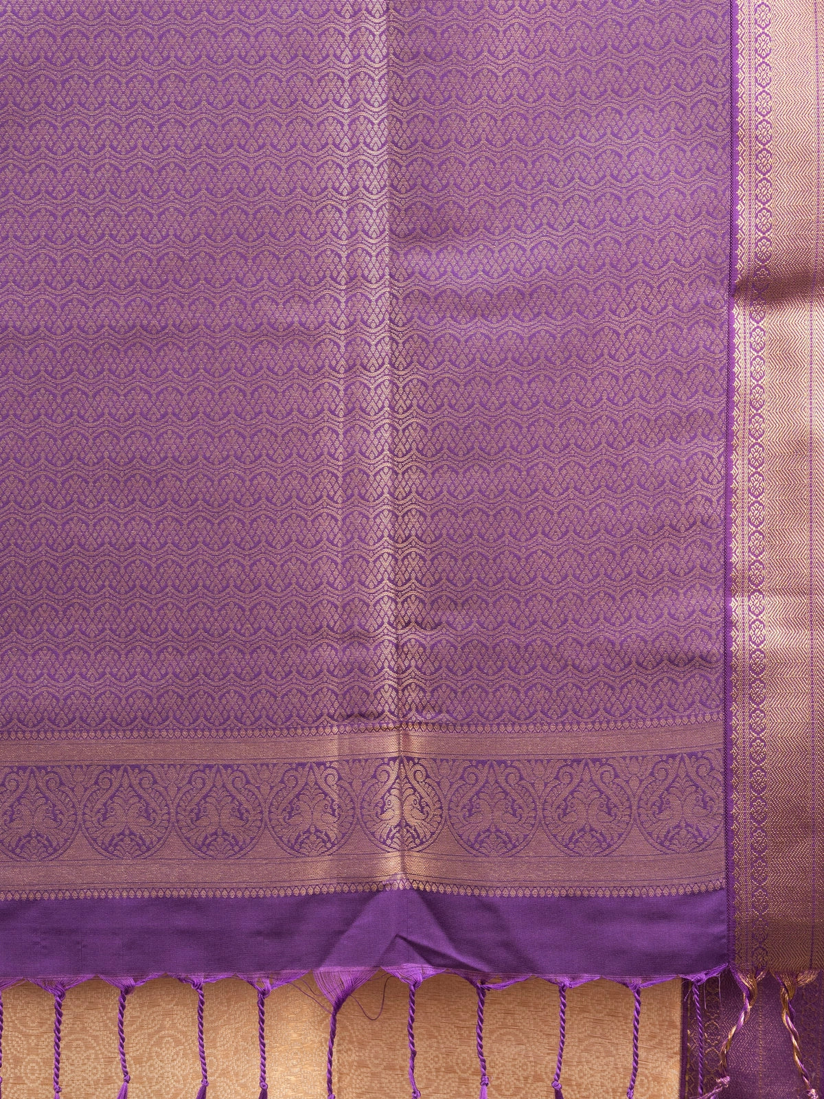 Beige Kanchipuram Fancy Silk saree with contrast purple and gold zari border and pallu