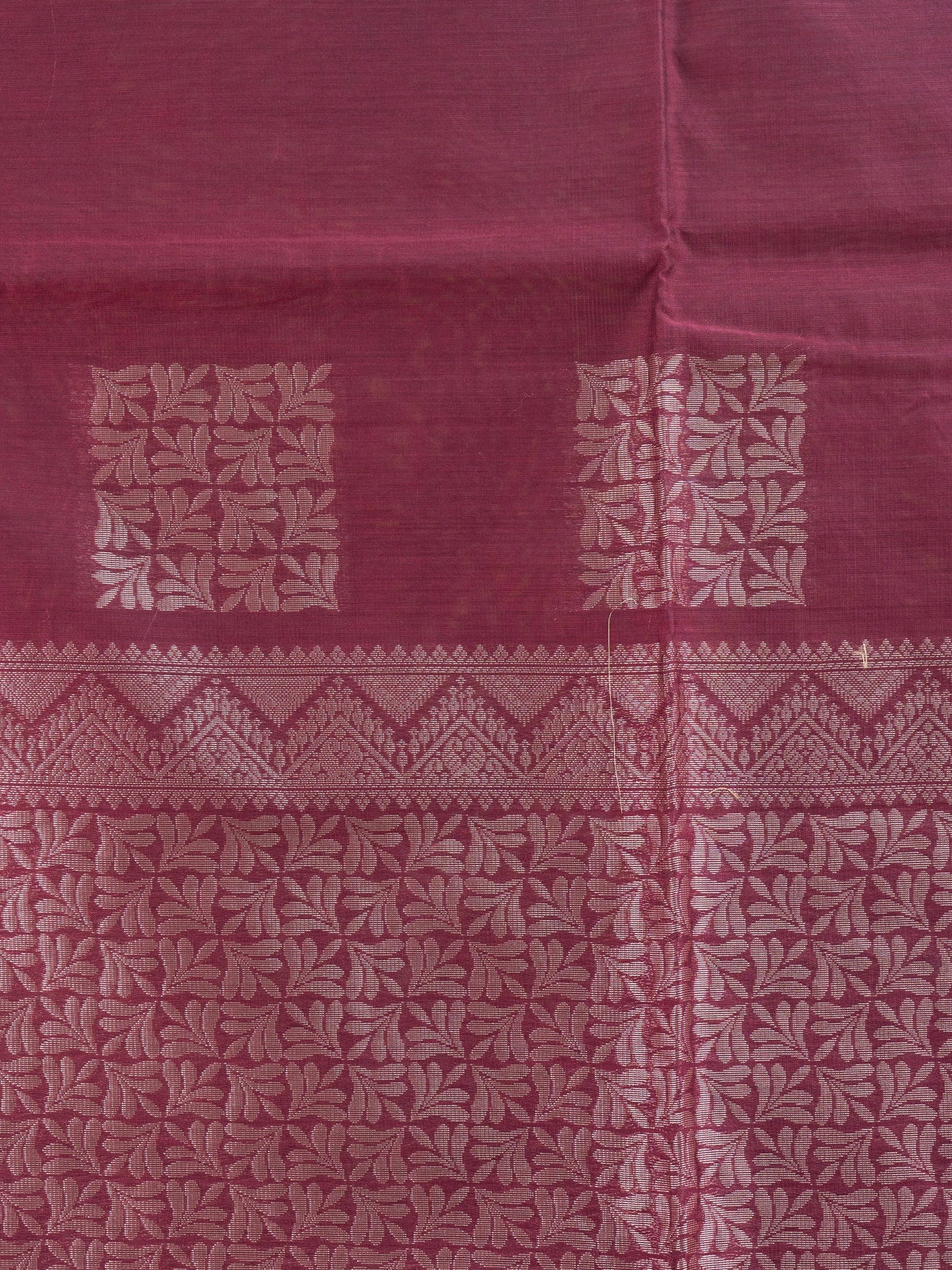 Maroon silk cotton saree with silver zari buttas and contrast woven border