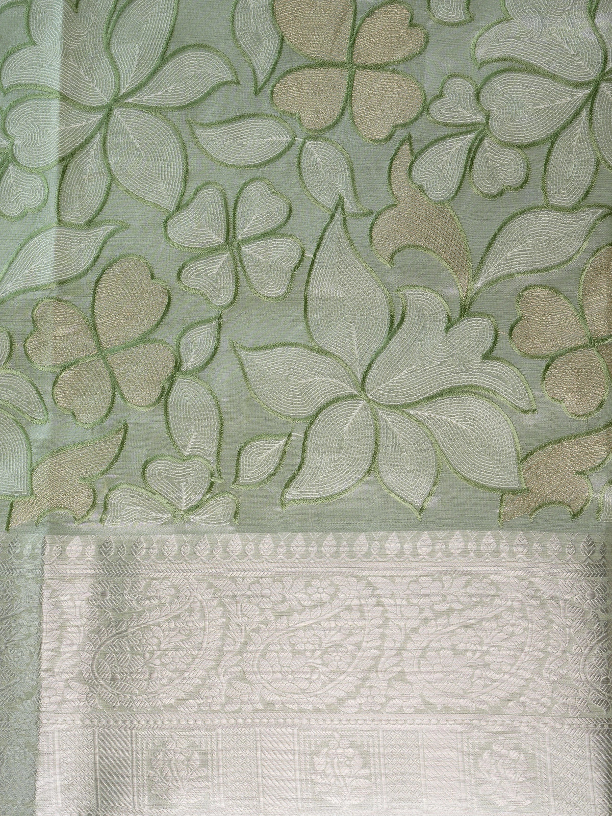 Sage green designer saree with cream-gold floral embroidery and silver zari border