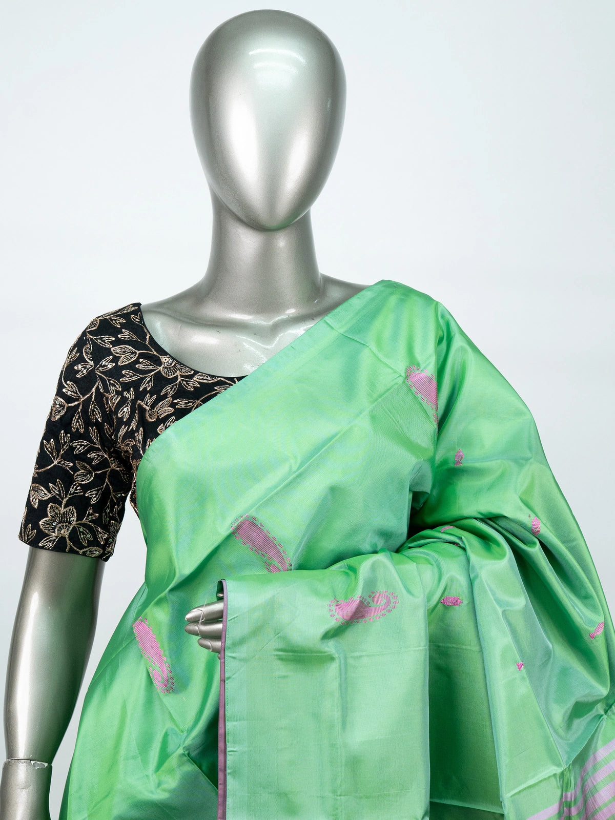 Green banana silk saree with mauve pink contrast pallu, paisley buttas and striped border
