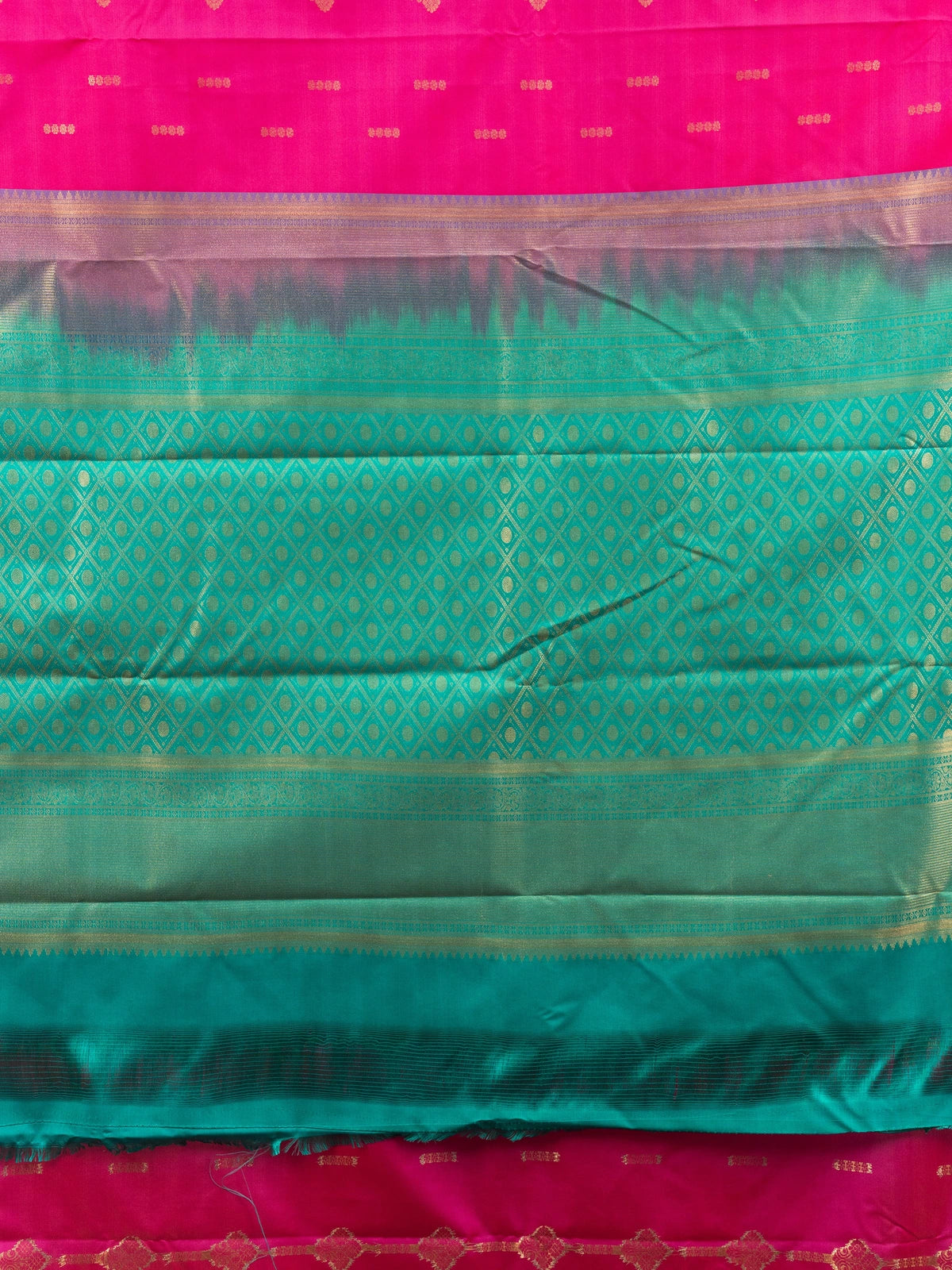 Rani pink Kanchipuram fancy silk saree with teal green contrast border, gold zari buttas and diamond-grid zari pallu
