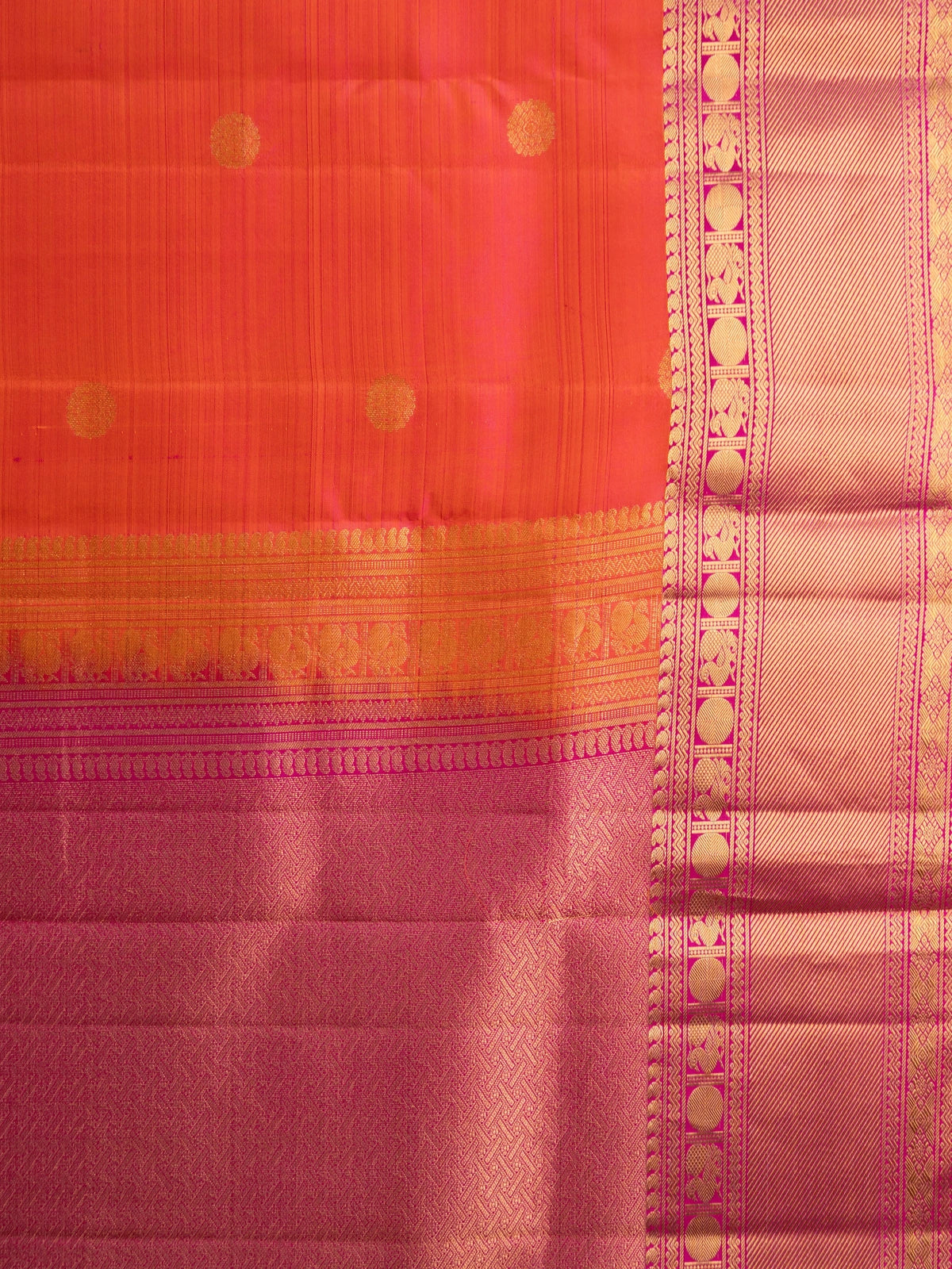 Orange pure Kanchipuram silk saree with contrast pink border and gold zari buttas