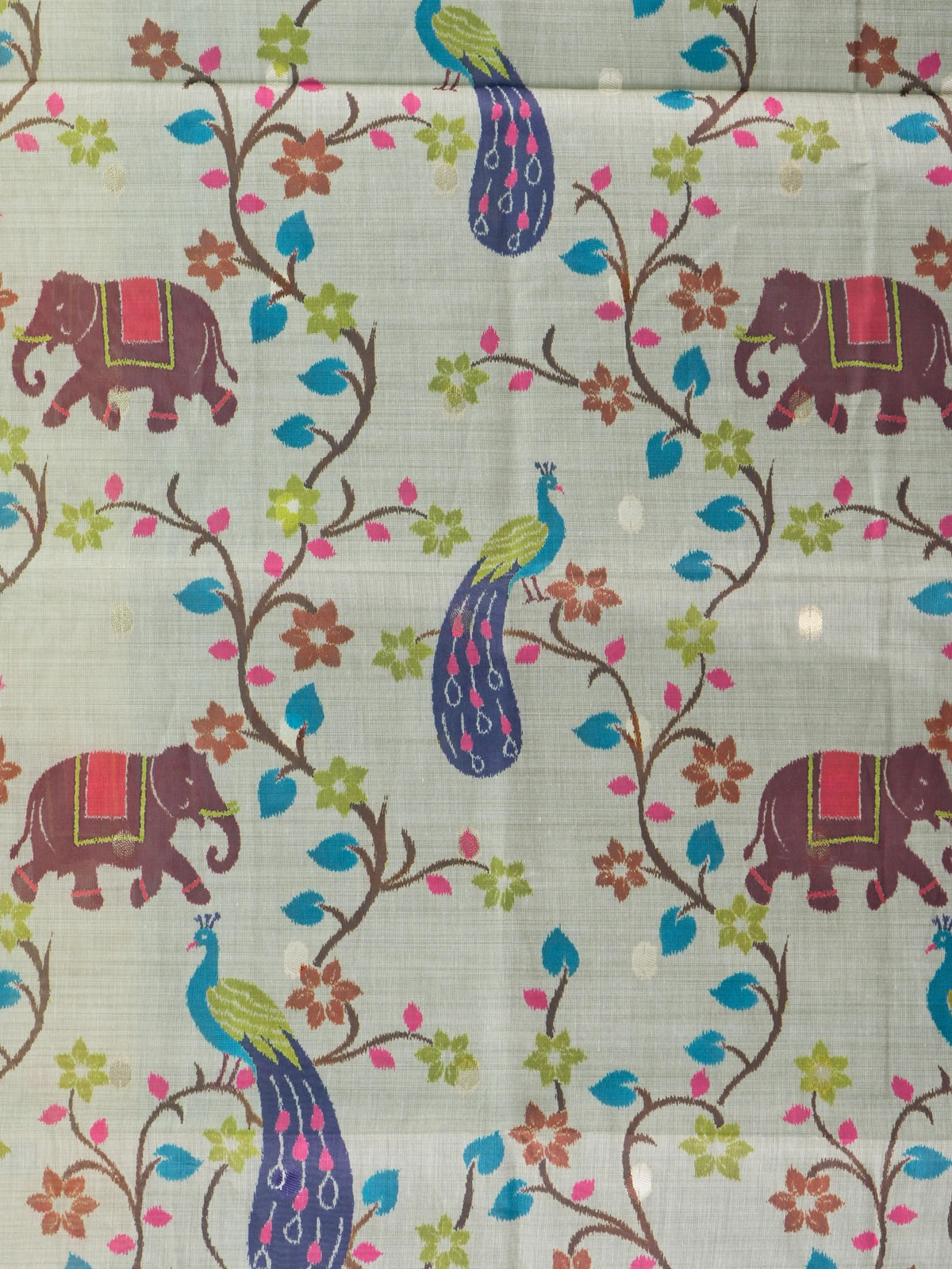 Cream linen cotton saree with peacock and elephant motifs and a teal silver zari border