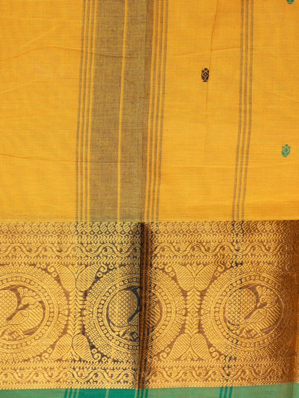 Mustard yellow Chettinad cotton saree with green contrast border, gold zari peacock motifs and woven buttis