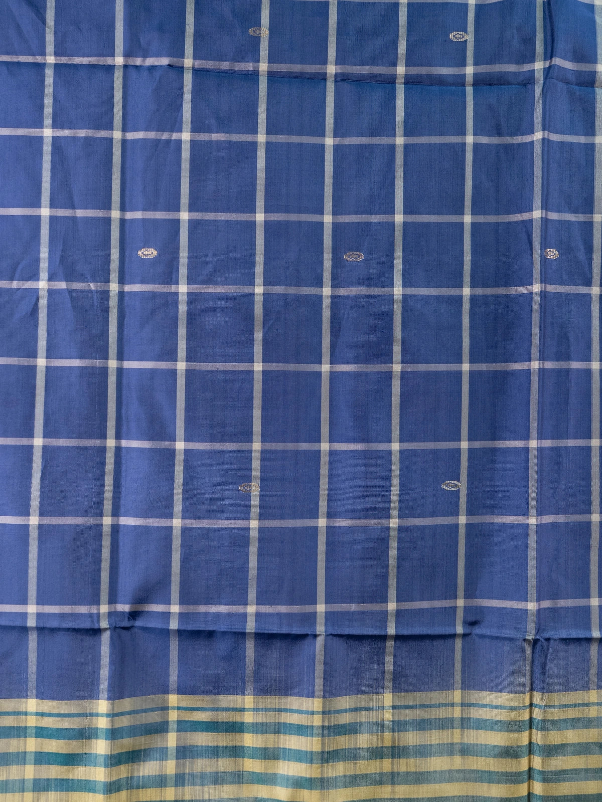 Royal blue and cream checked banana silk saree with woven butta motifs and a striped contrast pallu