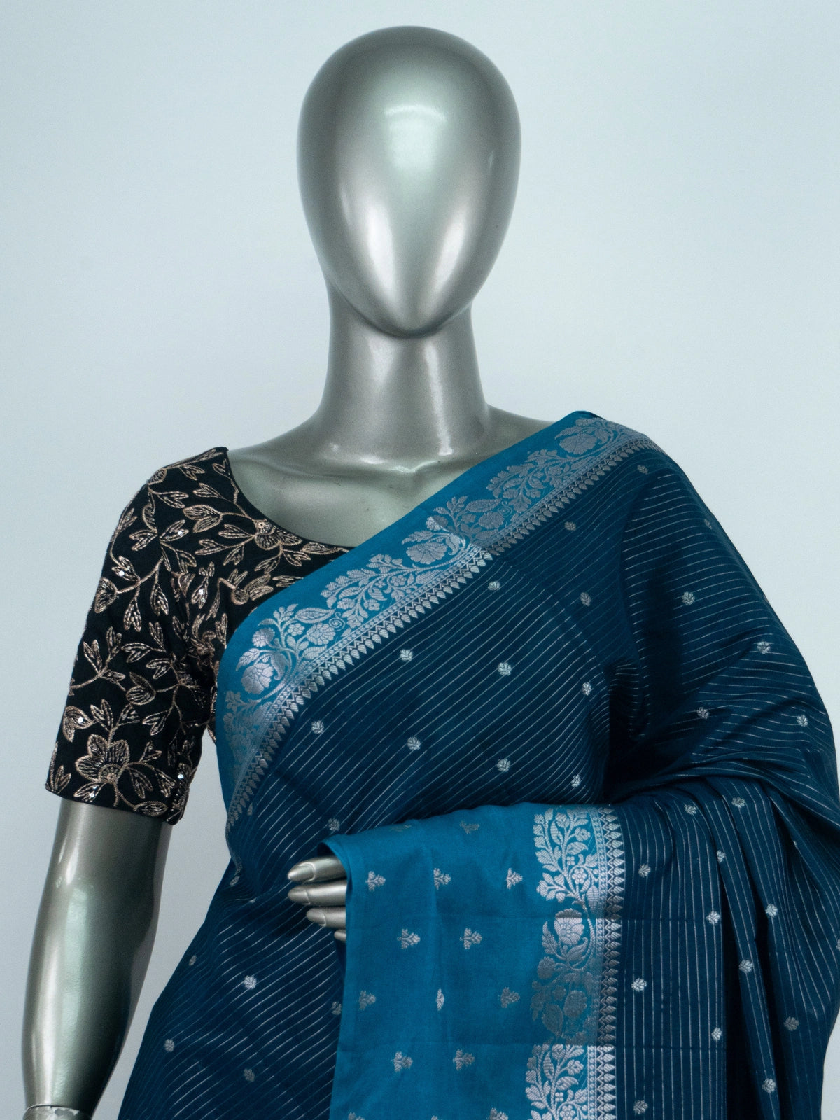 Teal blue semi raw silk saree with silver zari buttis and floral zari border