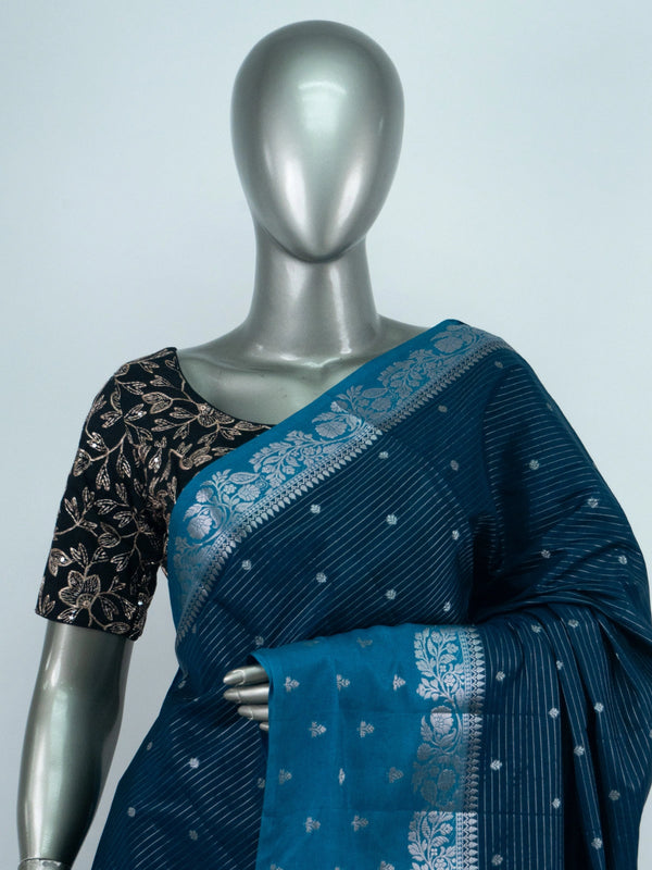 Teal blue semi raw silk saree with silver zari buttis and floral zari border