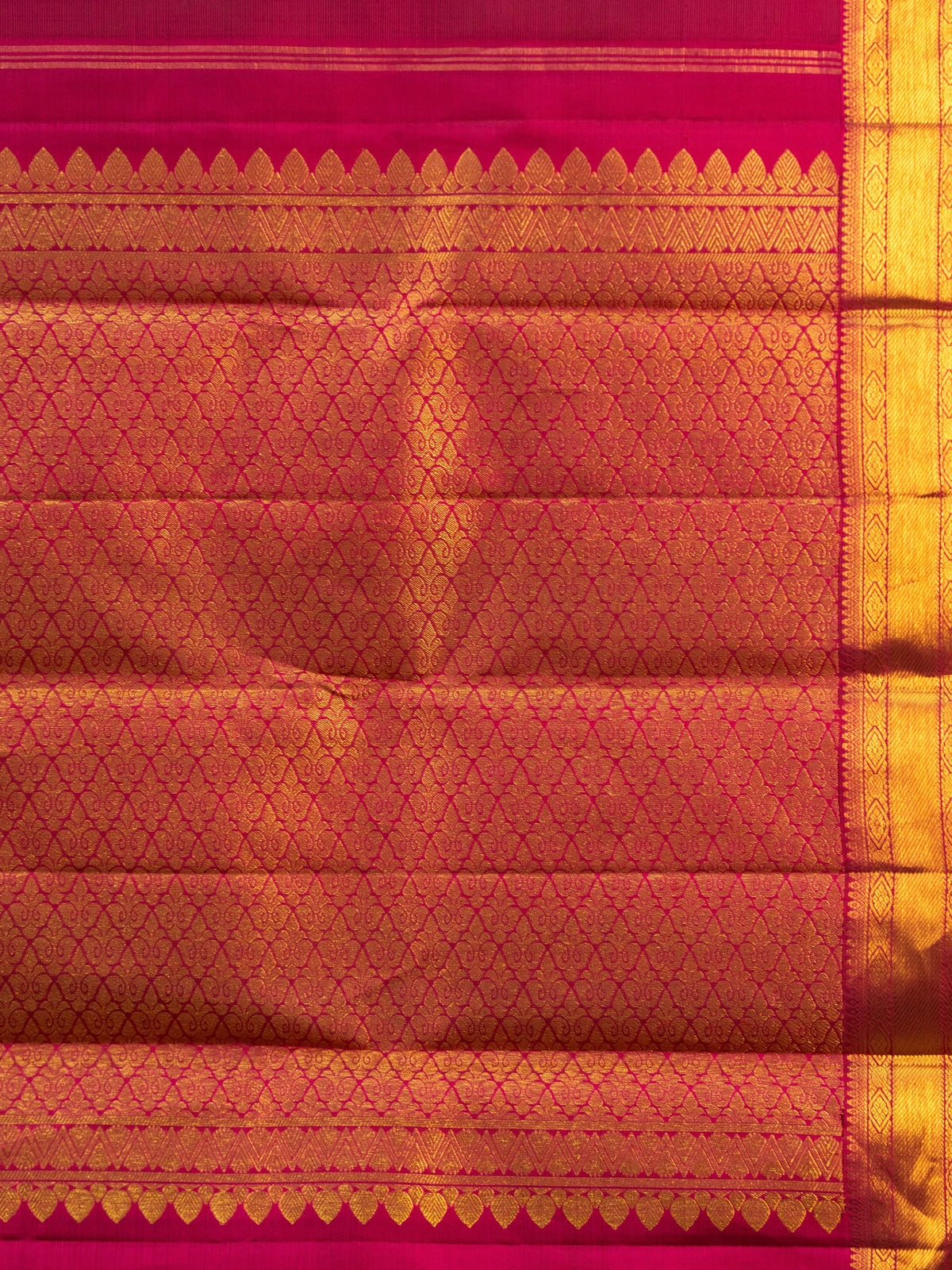 Maroon pure Kanchipuram silk saree with contrast pink and gold zari border and paisley buttas