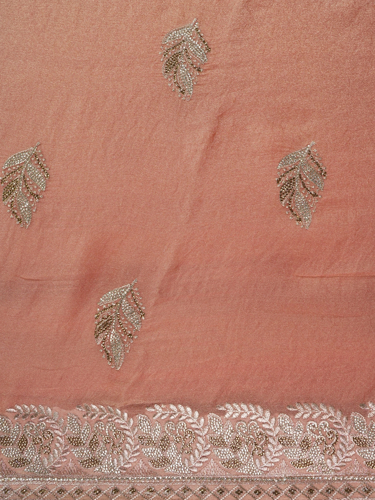 Peach shimmer tissue designer saree with embroidered leaf buttas and an ornate rose-gold border