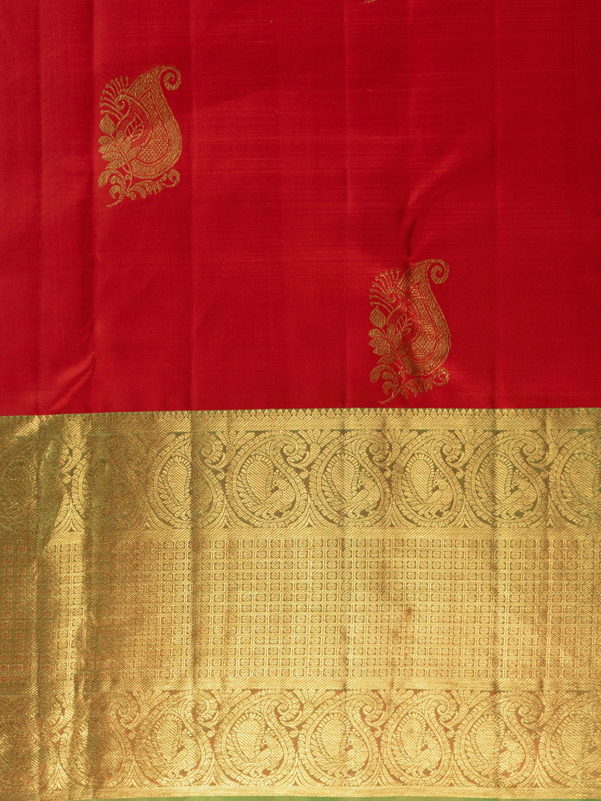 Red pure Kanchipuram silk saree with contrast green and gold zari border and paisley motifs