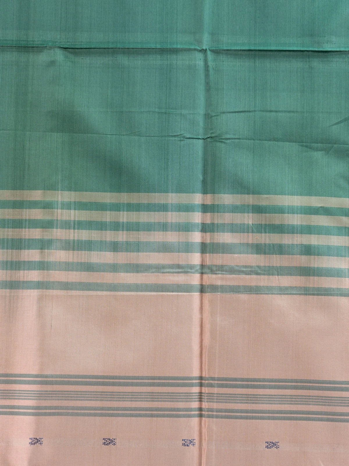 Bottle green banana silk saree with gold zari buttas and contrast peach striped pallu