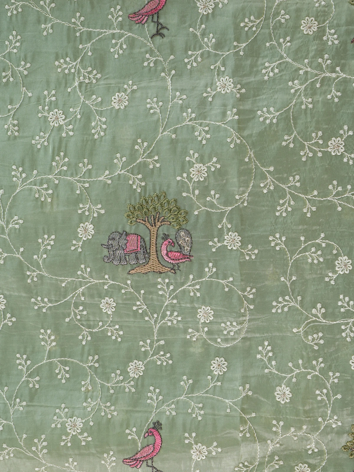 Sage green designer saree with white floral embroidery, pink bird and elephant motifs and pom-pom lace border