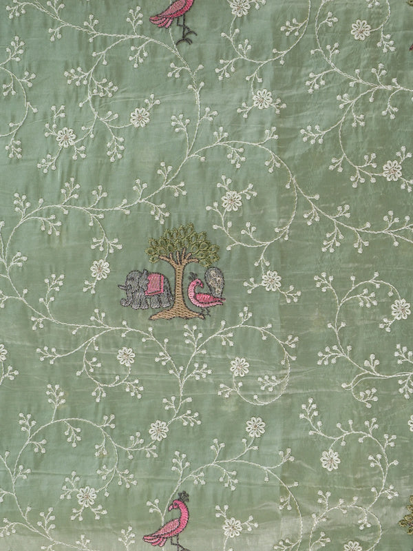 Sage green designer saree with white floral embroidery, pink bird and elephant motifs and pom-pom lace border