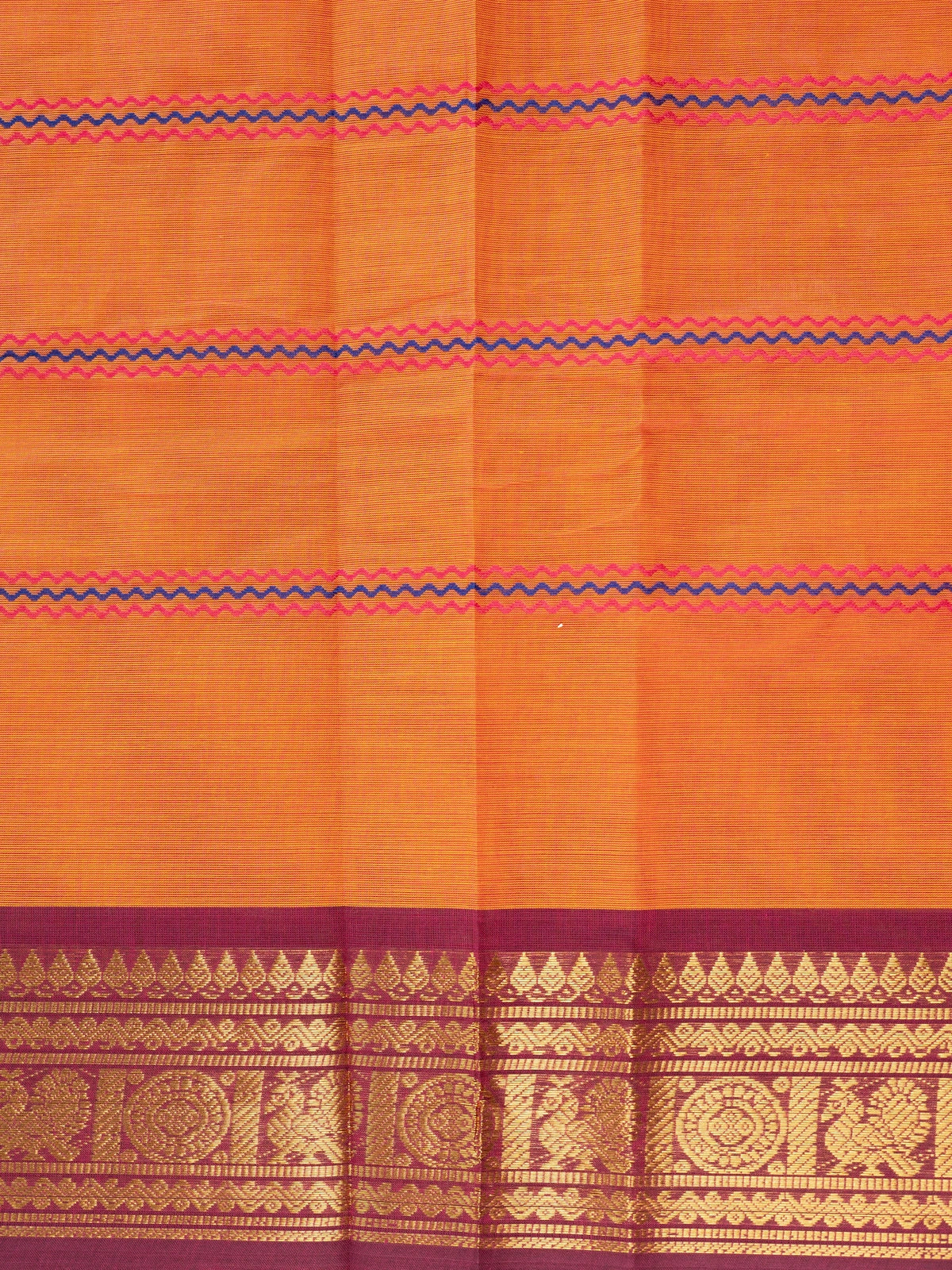 Rust orange Chettinad cotton saree with magenta gold zari border and pink-blue zigzag stripes