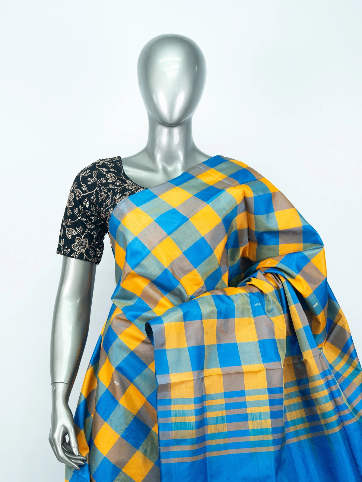 Blue and yellow checked banana silk saree with solid blue pallu and silver zari motifs