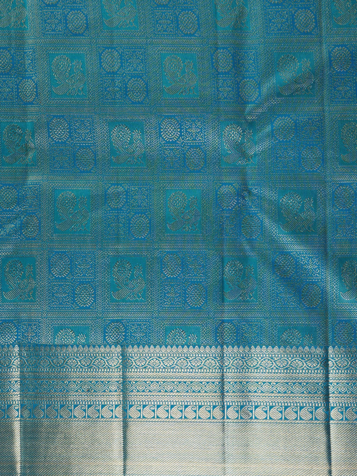 Peacock blue pure Kanchipuram silk saree with silver zari checkerboard motifs, broad zari border and jaali pallu