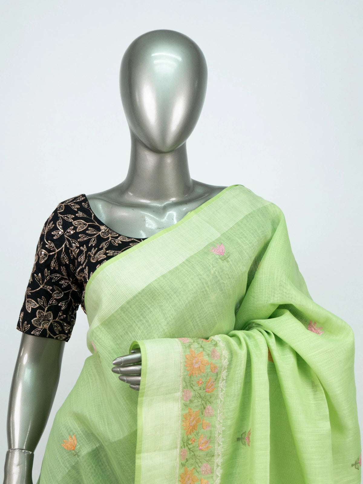 Pista green linen cotton saree with pink and orange floral embroidery and silver zari border