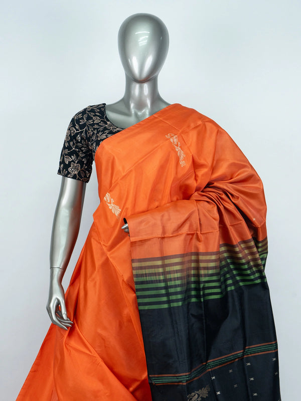Orange Banana Silk saree with contrast black striped pallu, gold zari buttas and embroidered black blouse