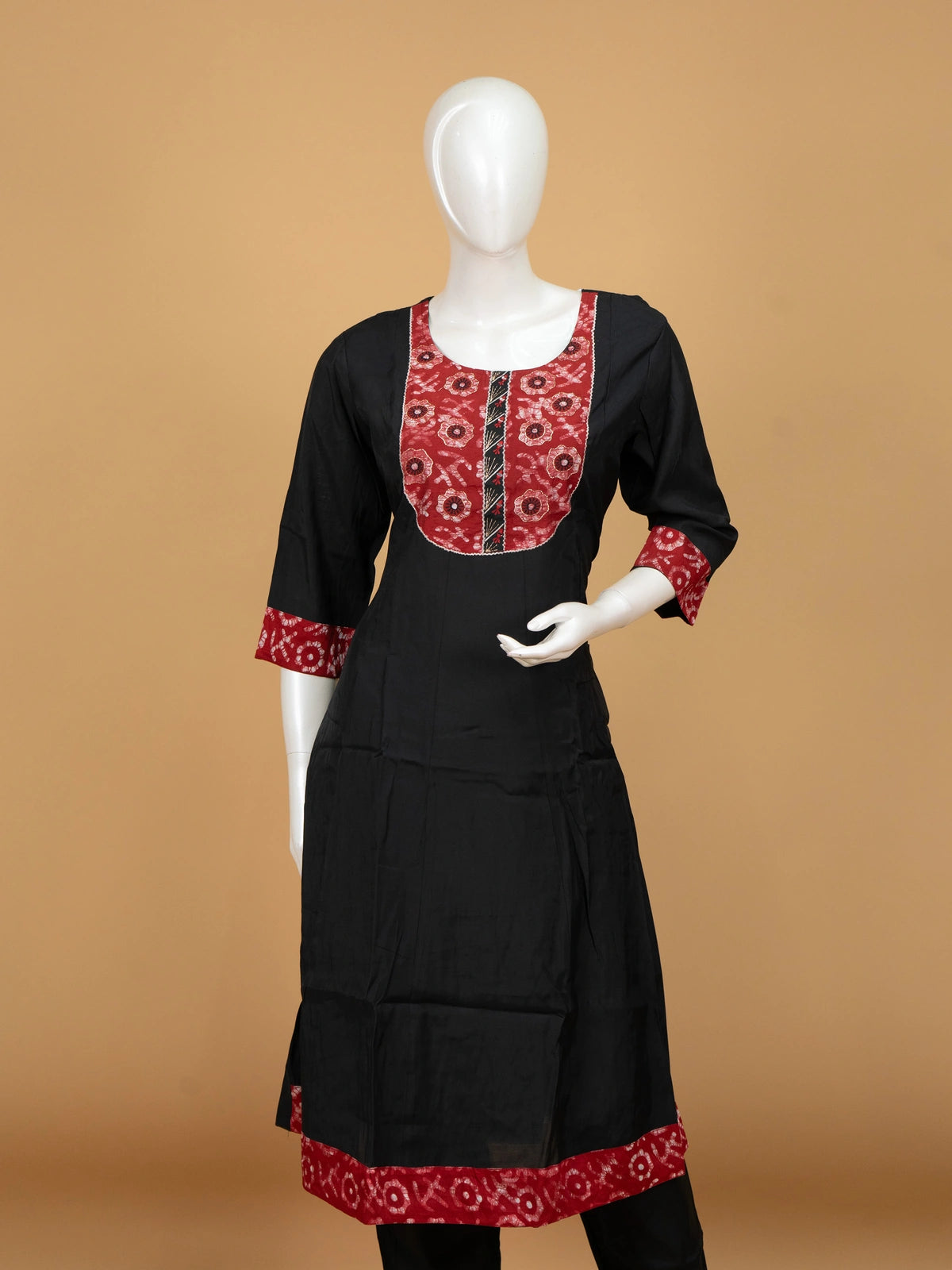 Black A-line cotton kurti set with red batik-print yoke and zari-bordered dupatta