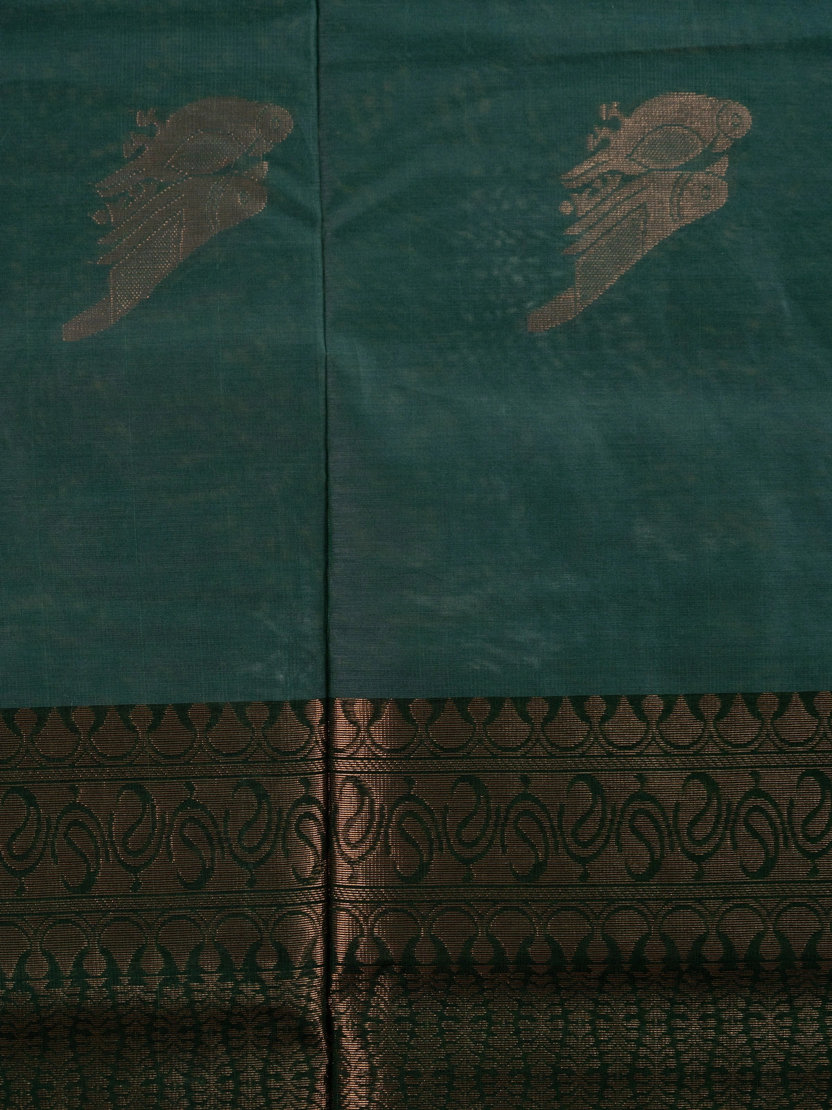Bottle green silk cotton saree with copper zari bird motifs and contrast zari border
