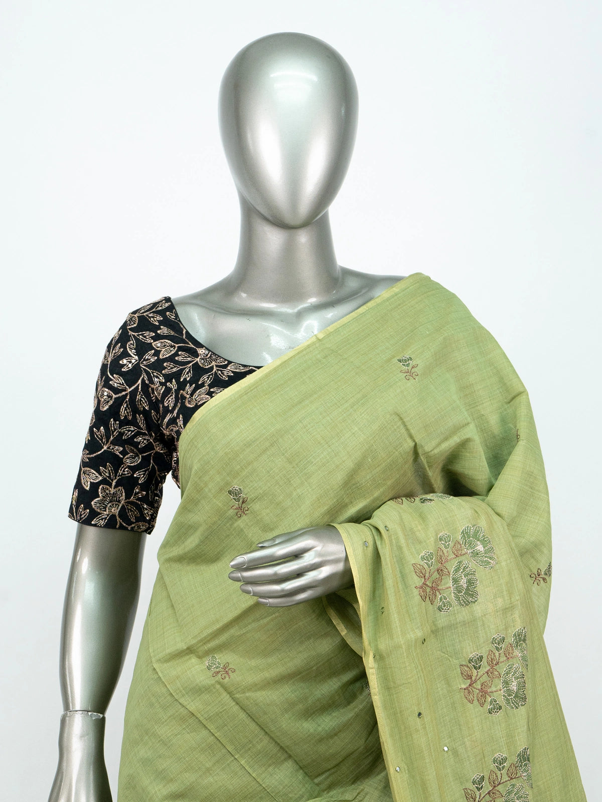 Mehndi green linen cotton saree with floral embroidery and tasselled pallu