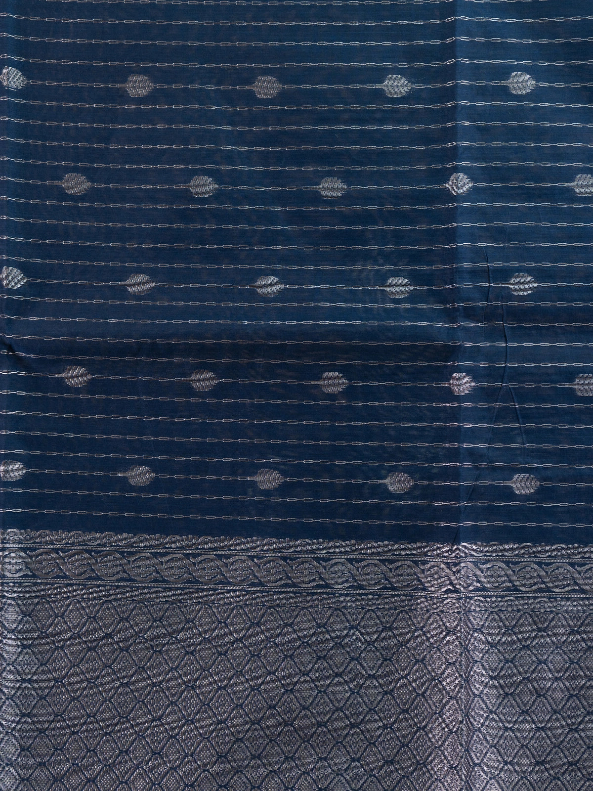 Navy blue silk cotton saree with silver zari stripes, buttis and ornate zari border
