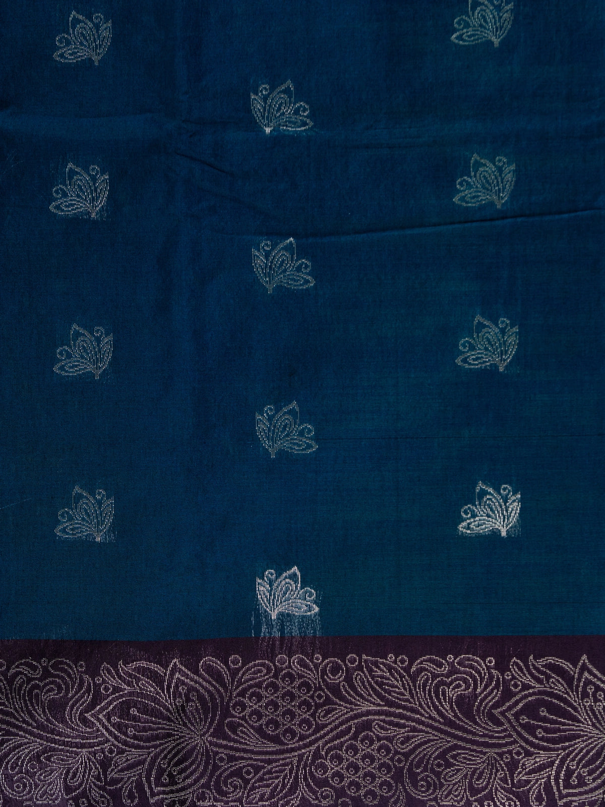 Peacock blue silk cotton saree with silver lotus buttas and contrast purple silver-woven border