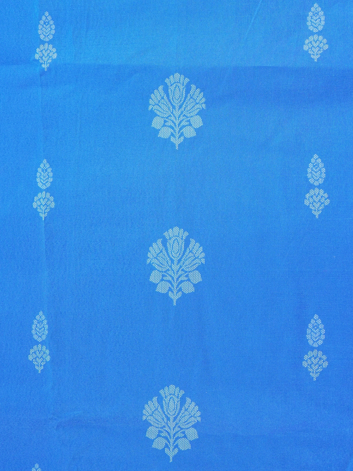 Blue Dola silk saree with white floral buti motifs and contrast zari border