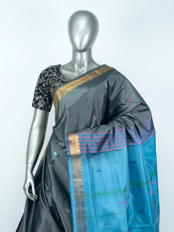 Grey silk saree with contrast blue pallu, gold zari border and black embroidered blouse