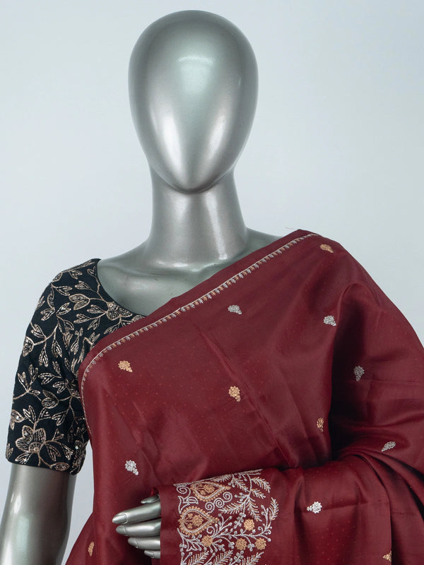 Maroon semi raw silk saree with embroidered pallu, buta motifs and contrast black embroidered blouse