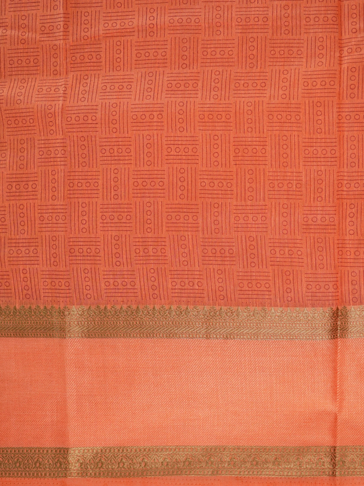 Orange semi tussar saree with gold zari border and geometric patterned body