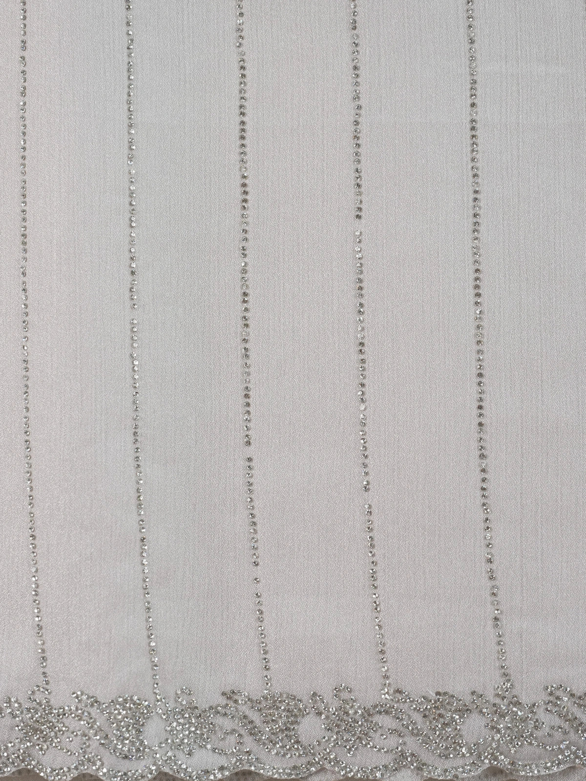 Light grey sheer designer saree with silver stone stripes and scalloped border, styled with a yellow embroidered blouse