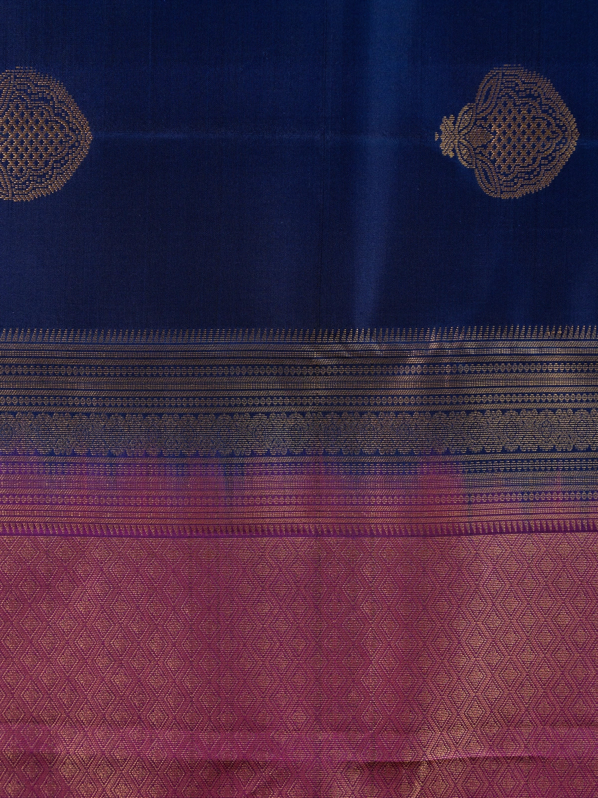 Navy blue pure Kanchipuram silk saree with magenta contrast border and gold zari buta motifs