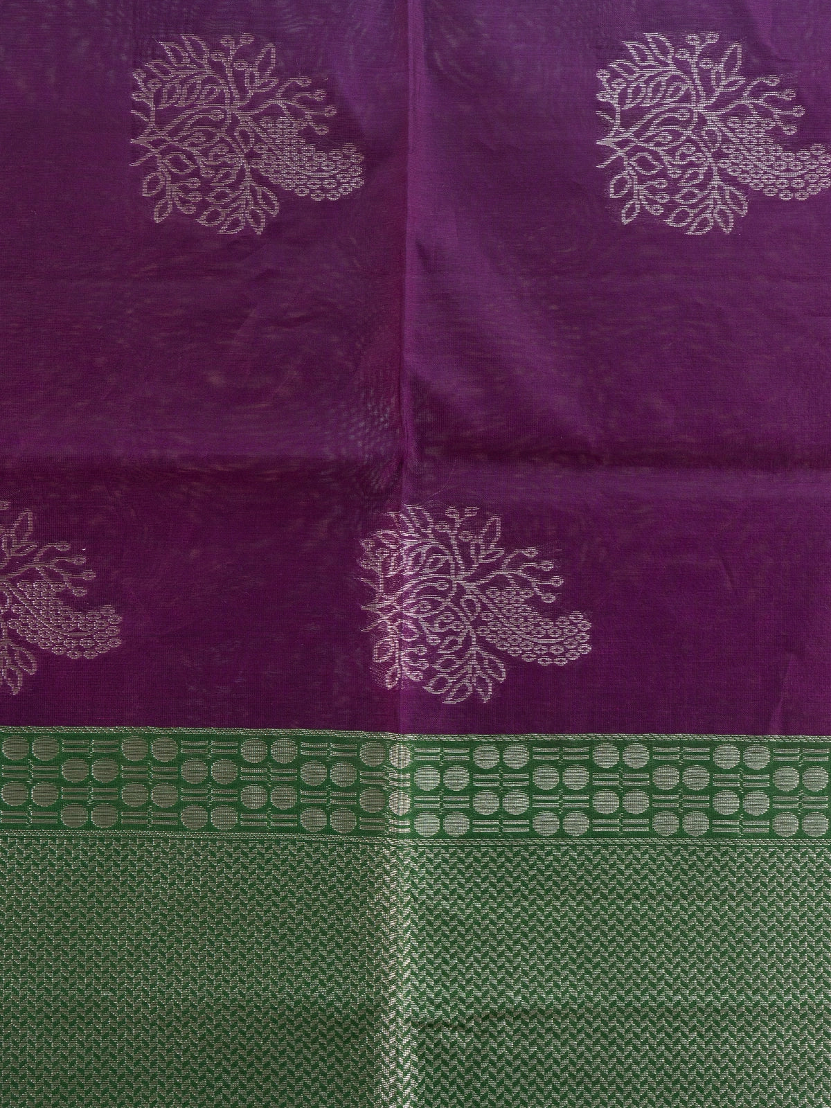 Purple silk cotton saree with silver zari floral buttas and contrast green zari border and pallu