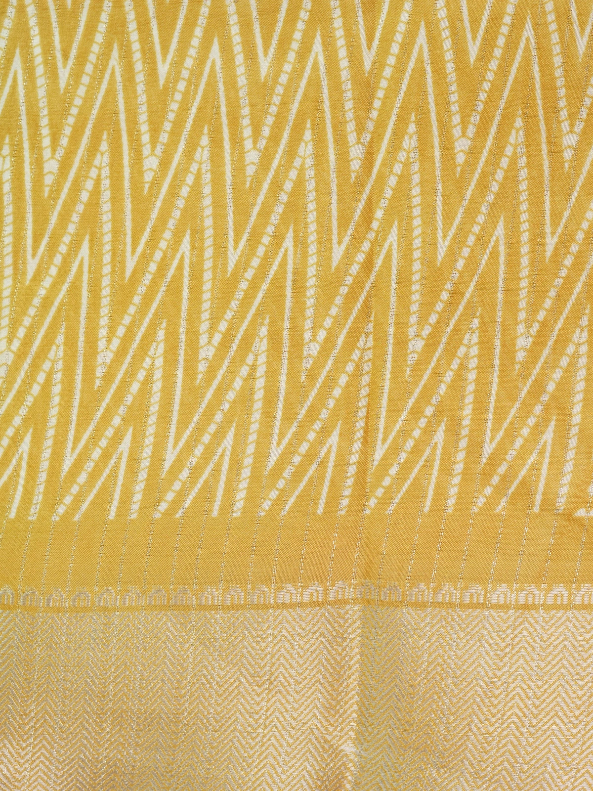 Yellow and white designer saree with zigzag print, gold zari border and tree motif pallu