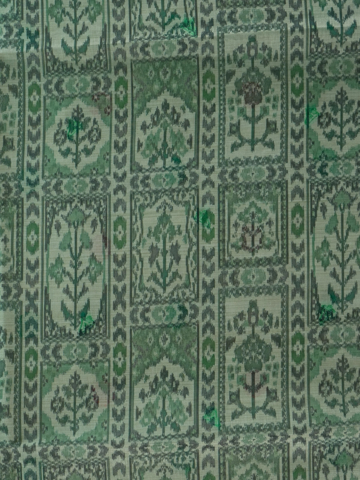 Sage green linen cotton saree with ikat-style motifs and Madhubani bird pallu